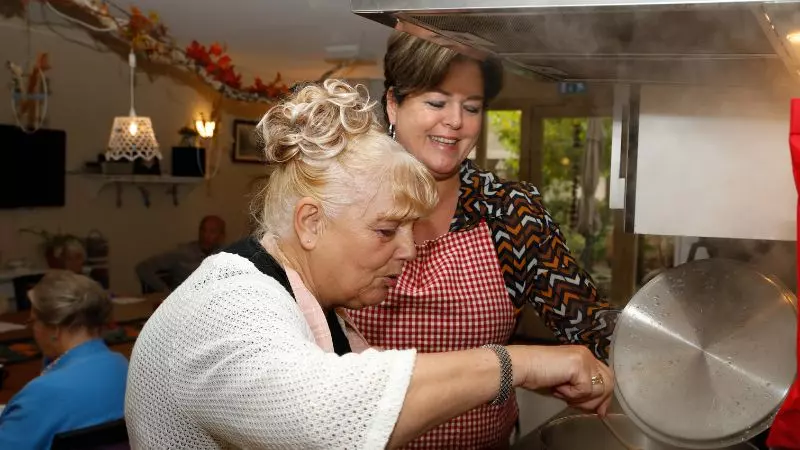 Twee vrijwilligers zijn eten aan het koken bij dagbesteding Sering van KleinGeluk